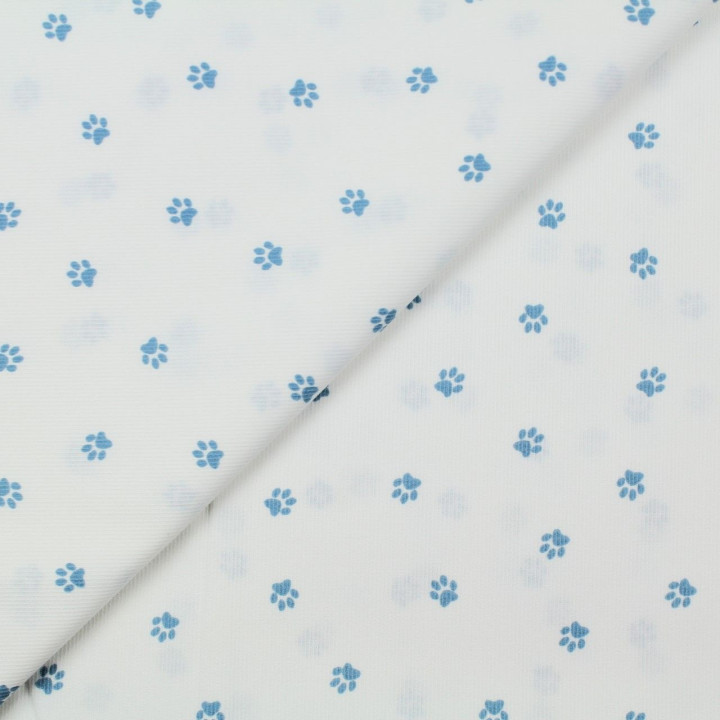 Tissu coton blanc milleraie imprimé empreinte pattes de chien bleu ciel