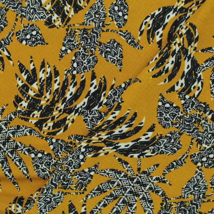 Tissu jersey polyester moutarde imprimé feuillage