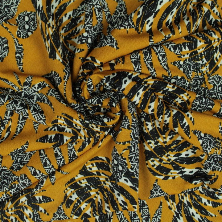 Tissu jersey polyester moutarde imprimé feuillage