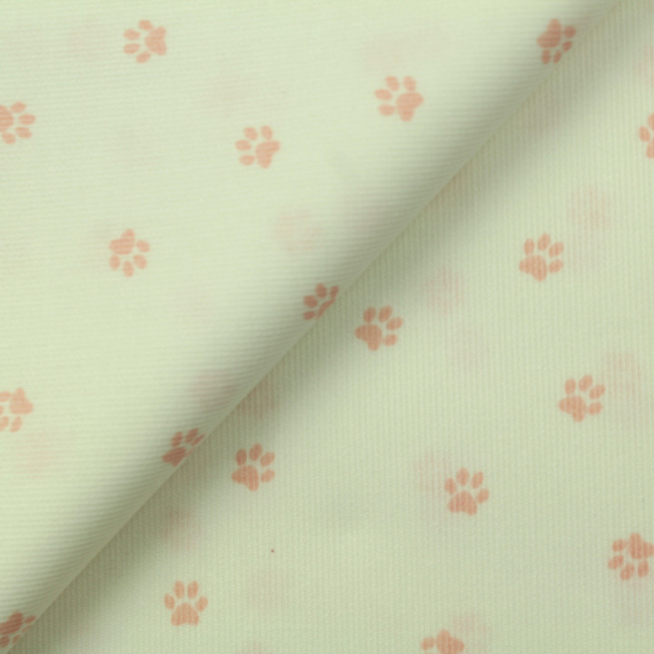 Tissu coton blanc milleraie imprimé pattes de chien rose