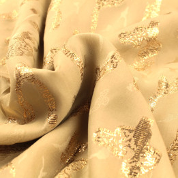 Tissu Tlija beige à motifs géométriques dorés élégants.