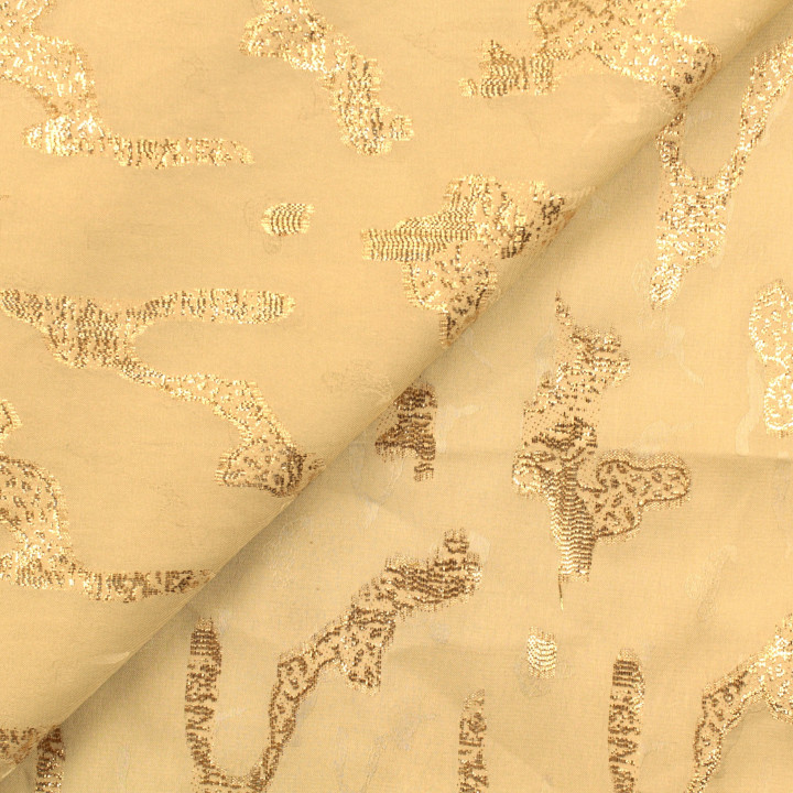 Tissu Tlija beige à motifs géométriques dorés élégants.