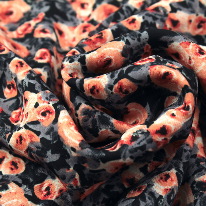 Tissu polyester noir à imprimé floral gris et orange