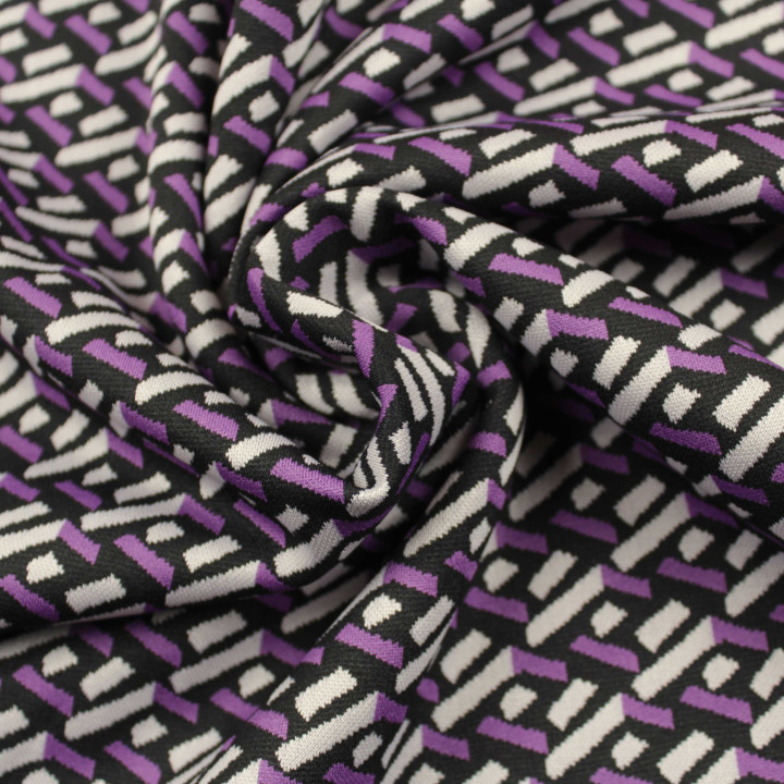 Tissu jersey noir motifs géométriques blancs et violets peu extensible