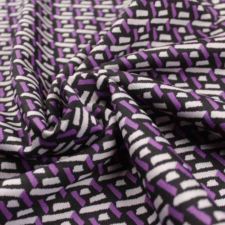Tissu jersey noir motifs géométriques blancs et violets peu extensible