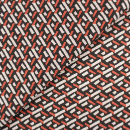 Tissu jersey noir motifs géométriques blancs et orange peu extensible