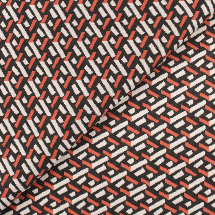 Tissu jersey noir motifs géométriques blancs et orange peu extensible