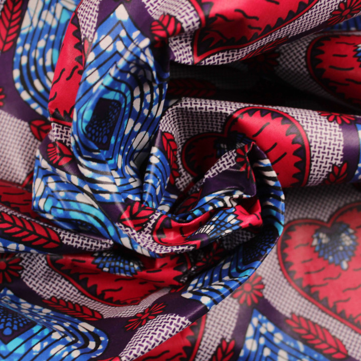 Tissu coton Wax imprimé géométrique rouge, bleu et rose
